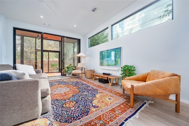 living room with wood finished floors, recessed lighting, and baseboards