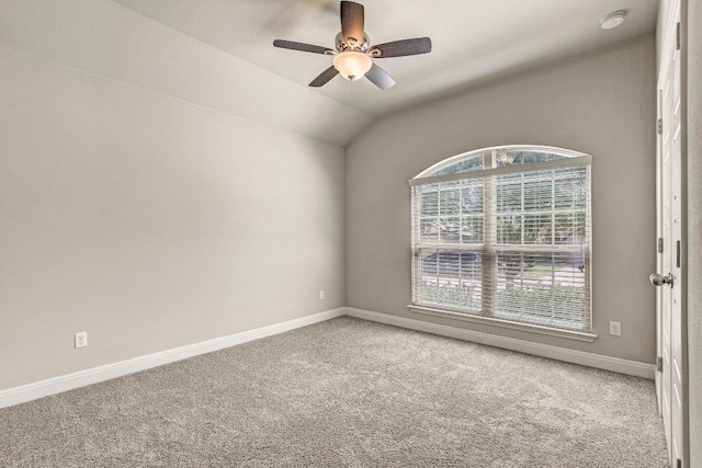 spare room with carpet, baseboards, ceiling fan, a smoke detector, and vaulted ceiling
