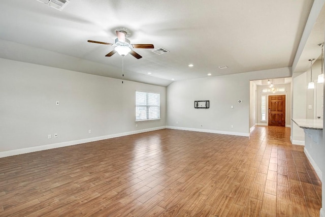 unfurnished living room with a ceiling fan, light wood-type flooring, baseboards, recessed lighting, and lofted ceiling