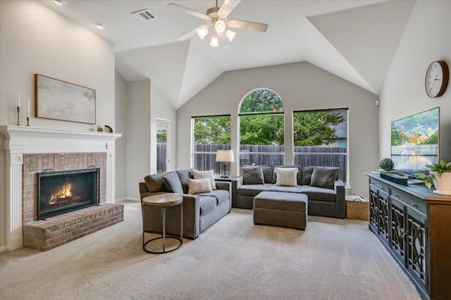 living area with carpet floors, ceiling fan, a fireplace, and lofted ceiling