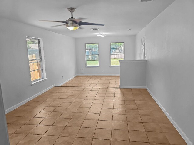 1801 Rock Creek Dr, Round Rock, TX 78681 - spare room featuring a ceiling fan, light tile patterned floors, and baseboards
