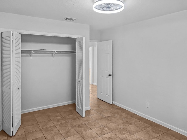1801 Rock Creek Dr, Round Rock, TX 78681 - unfurnished bedroom featuring a closet, light tile patterned flooring, and baseboards