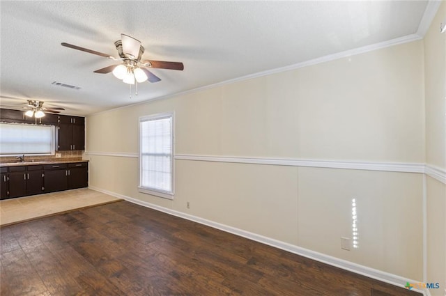 1518 S 37th St, Temple, TX 76504 - unfurnished room with wood finished floors, ceiling fan, crown molding, a sink, and baseboards