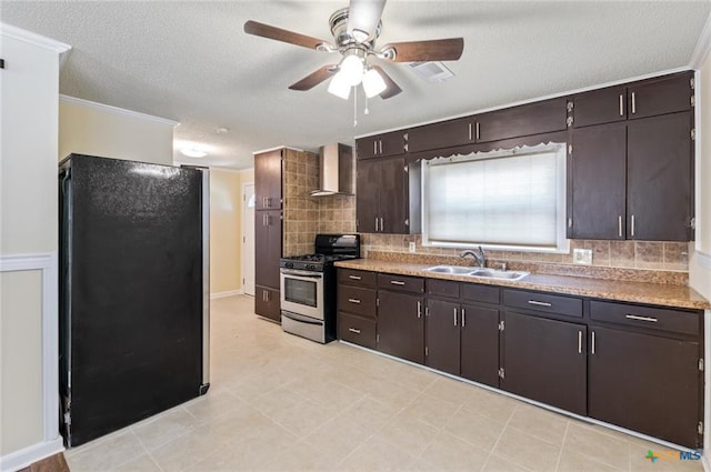 1518 S 37th St, Temple, TX 76504 - kitchen featuring stainless steel gas stove, a sink, wall chimney exhaust hood, a ceiling fan, and tasteful backsplash