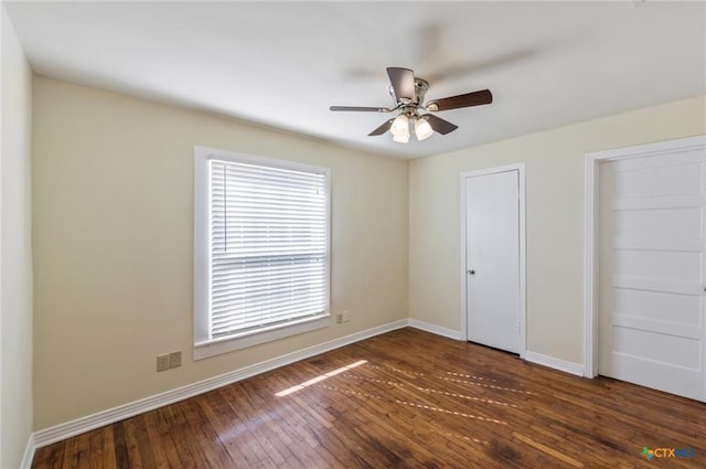 1518 S 37th St, Temple, TX 76504 - unfurnished bedroom with baseboards, hardwood / wood-style flooring, ceiling fan, and multiple closets