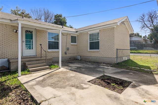 1518 S 37th St, Temple, TX 76504 - back of property with brick siding, fence, a patio, and entry steps