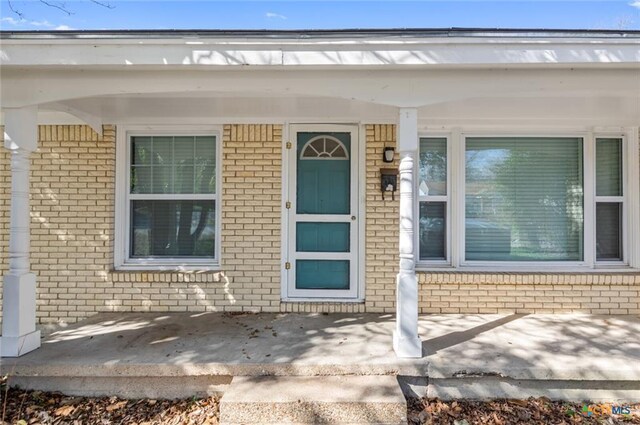 1518 S 37th St, Temple, TX 76504 - view of exterior entry with brick siding and a porch