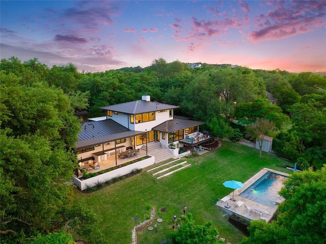 402 Buckeye Trl, West Lake Hills, TX 78746 - aerial view at dusk of a view of trees and view of pool