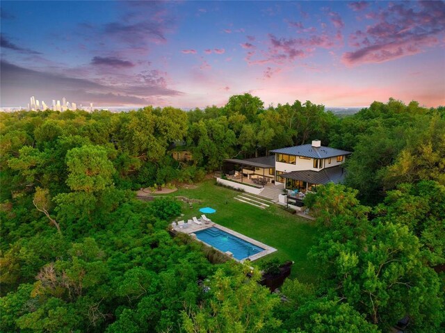 402 Buckeye Trl, West Lake Hills, TX 78746 - aerial view at dusk of a view of trees and view of pool