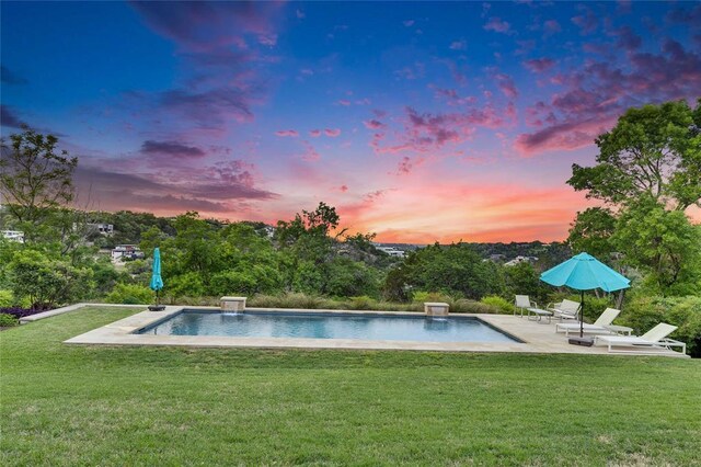 402 Buckeye Trl, West Lake Hills, TX 78746 - pool at dusk featuring a patio area, a yard, and an outdoor pool