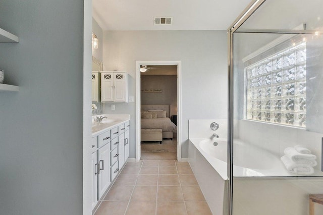 418 Rosedale Blvd, Georgetown, TX 78628 - bathroom featuring tile patterned floors, vanity, a bath, a shower with door, and ensuite bath