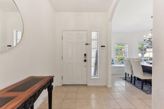 418 Rosedale Blvd, Georgetown, TX 78628 - foyer entrance featuring a chandelier, light tile patterned floors, arched walkways, and baseboards
