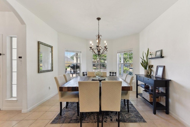 418 Rosedale Blvd, Georgetown, TX 78628 - dining space with a chandelier, light tile patterned floors, arched walkways, and baseboards