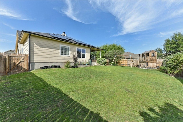 418 Rosedale Blvd, Georgetown, TX 78628 - back of house featuring roof mounted solar panels and a gate