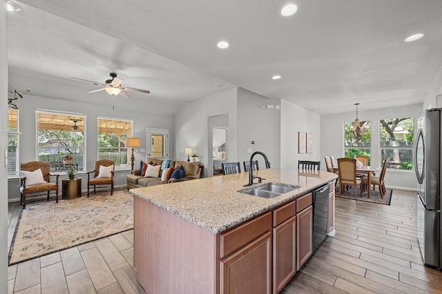 10216 Chaska Cv, Austin, TX 78739 - kitchen with a sink, freestanding refrigerator, wood finish floors, dishwasher, and recessed lighting