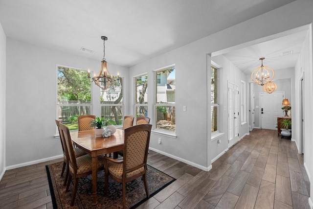 10216 Chaska Cv, Austin, TX 78739 - dining area featuring a chandelier, wood finished floors, and healthy amount of natural light