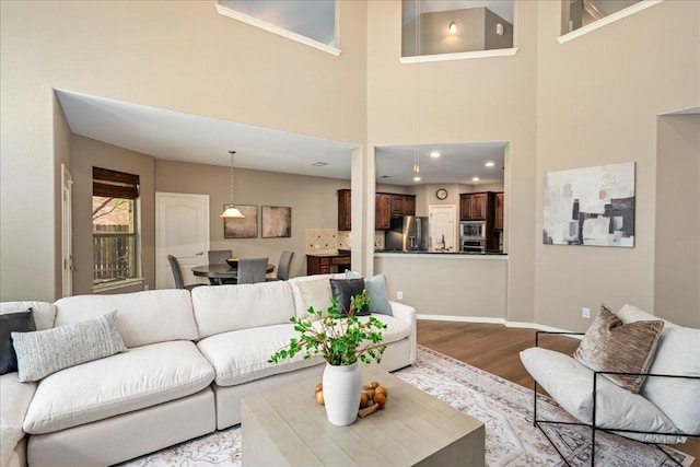 12920 Little Dipper Path, Austin, TX 78732 - living room with wood finished floors, a towering ceiling, and baseboards