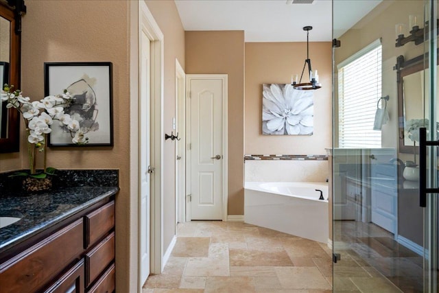 12920 Little Dipper Path, Austin, TX 78732 - bathroom with vanity, a garden tub, baseboards, a shower stall, and stone finish floors