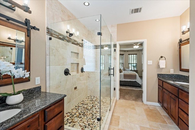 12920 Little Dipper Path, Austin, TX 78732 - ensuite bathroom featuring a shower stall, two vanities, a ceiling fan, baseboards, and recessed lighting