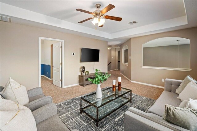 12920 Little Dipper Path, Austin, TX 78732 - living room with carpet, arched walkways, a raised ceiling, and ceiling fan