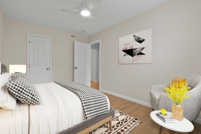2401 Manor Rd Unit 235, Austin, TX 78722 - bedroom featuring baseboards, wood finished floors, and ceiling fan