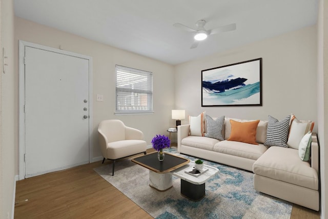 2401 Manor Rd Unit 235, Austin, TX 78722 - living area with light wood-style floors, ceiling fan, and baseboards