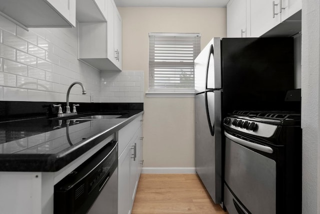 2401 Manor Rd Unit 235, Austin, TX 78722 - kitchen with appliances with stainless steel finishes, dark countertops, tasteful backsplash, a sink, and light wood-type flooring