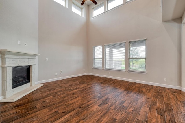 3351 Vasquez Pl, Round Rock, TX 78665 - unfurnished living room with a towering ceiling, a ceiling fan, plenty of natural light, and dark wood-style floors