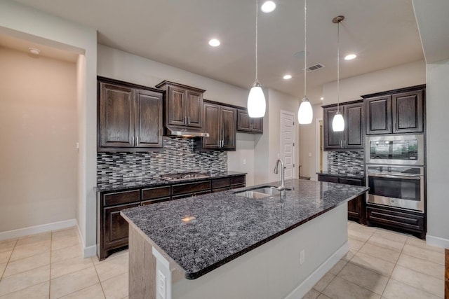 kitchen featuring a sink, tasteful backsplash, light tile patterned floors, dark brown cabinetry, and recessed lighting