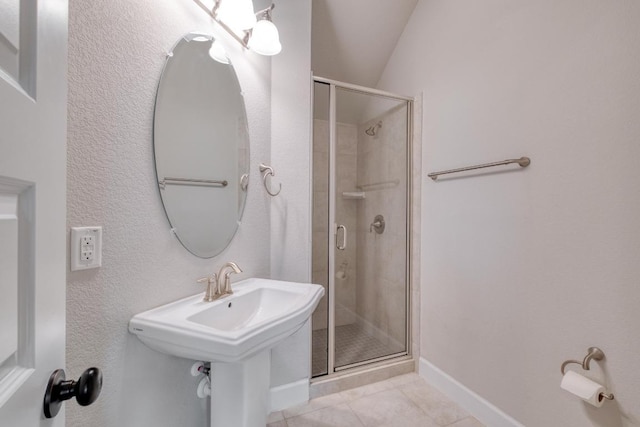 bathroom featuring a shower stall, tile patterned flooring, and baseboards