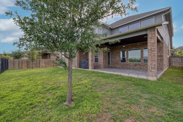 back of house featuring a patio and brick siding