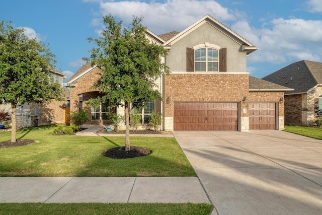 3351 Vasquez Pl, Round Rock, TX 78665 - traditional home featuring a front lawn, driveway, brick siding, and stucco siding