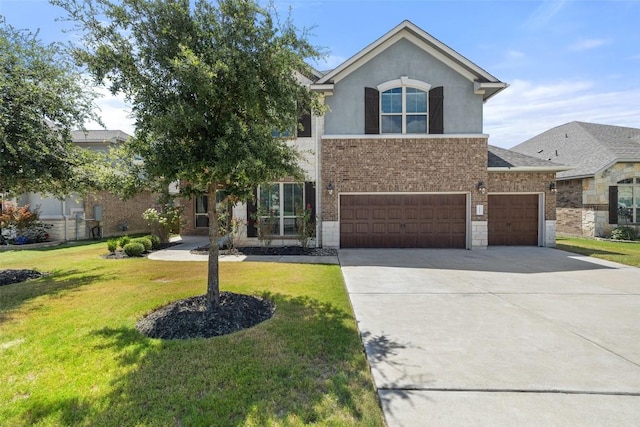 3351 Vasquez Pl, Round Rock, TX 78665 - view of front facade featuring a front lawn, driveway, a garage, stucco siding, and brick siding