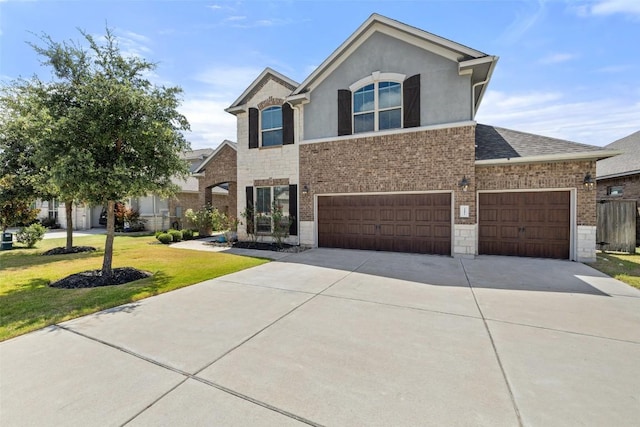 3351 Vasquez Pl, Round Rock, TX 78665 - traditional-style house featuring driveway, a front yard, stone siding, and a garage