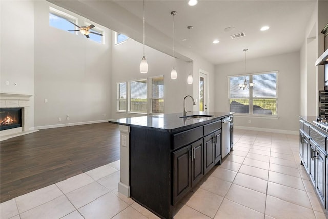 3351 Vasquez Pl, Round Rock, TX 78665 - kitchen with recessed lighting, stainless steel dishwasher, dark cabinets, open floor plan, and ceiling fan