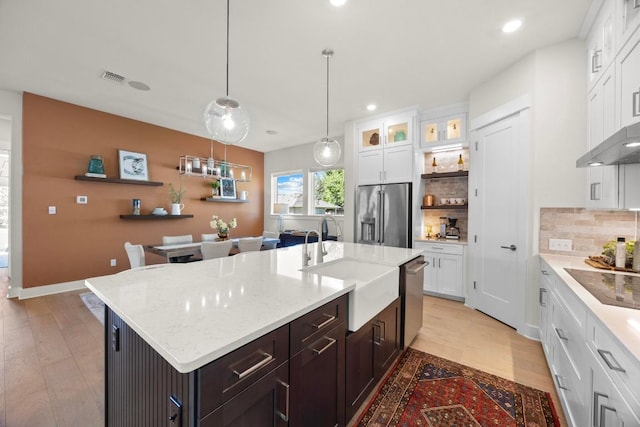 105 Monterey Oak Trl, Georgetown, TX 78628 - kitchen with stainless steel appliances, a sink, white cabinetry, backsplash, and recessed lighting
