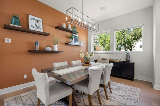 105 Monterey Oak Trl, Georgetown, TX 78628 - dining space featuring a chandelier, baseboards, and wood finished floors