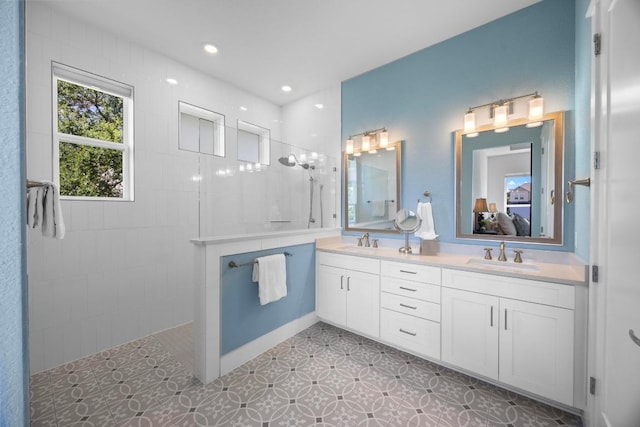 105 Monterey Oak Trl, Georgetown, TX 78628 - ensuite bathroom with walk in shower, double vanity, tile patterned floors, and recessed lighting