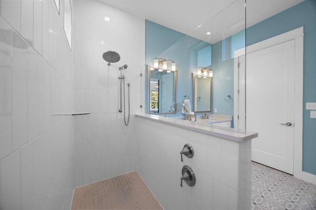 105 Monterey Oak Trl, Georgetown, TX 78628 - bathroom featuring tiled shower, a sink, and tile patterned floors