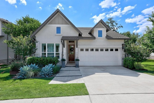 105 Monterey Oak Trl, Georgetown, TX 78628 - view of front facade featuring stucco siding, concrete driveway, a front lawn, an attached garage, and stone siding