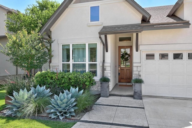 105 Monterey Oak Trl, Georgetown, TX 78628 - view of exterior entry with stucco siding, a garage, stone siding, and a shingled roof
