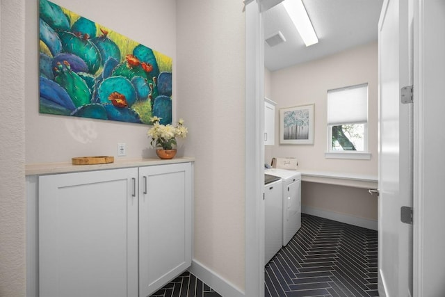 105 Monterey Oak Trl, Georgetown, TX 78628 - laundry area featuring washing machine and dryer, cabinet space, baseboards, and tile patterned floors