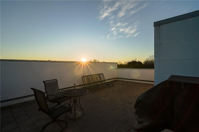 patio terrace at dusk with a baseboard heating unit