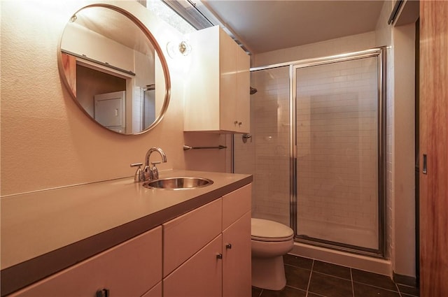 full bathroom with a shower stall, tile patterned floors, toilet, and vanity