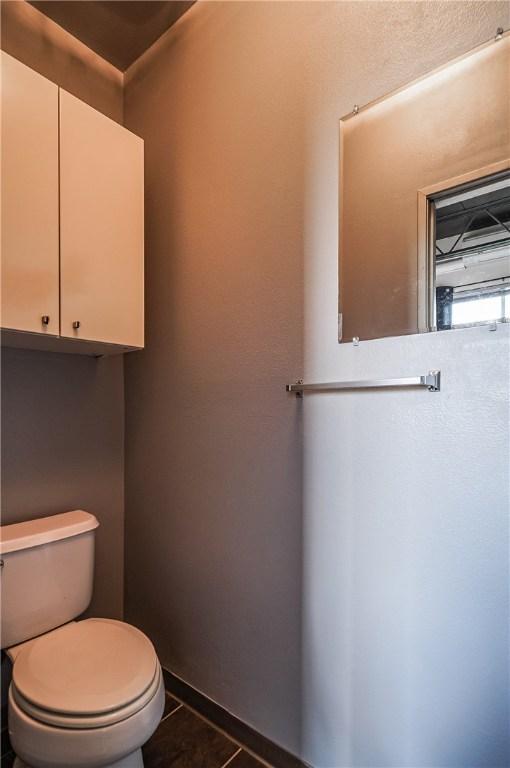 bathroom with toilet and tile patterned flooring