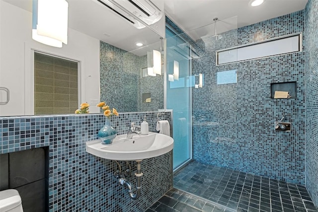 5804 Kaelan Cv, Austin, TX 78730 - full bath with tile patterned floors, a shower stall, a wall unit AC, tile walls, and a sink