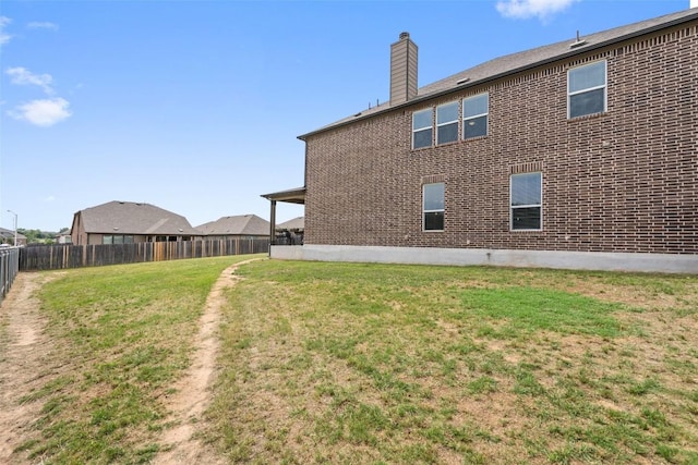 270 Johnny Cake Dr, Kyle, TX 78640 - back of property with a chimney and brick siding