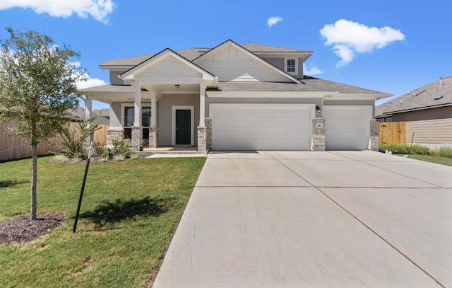 246 Salt Springs Rd, Kyle, TX 78640 - craftsman inspired home featuring a garage, stone siding, concrete driveway, and a porch