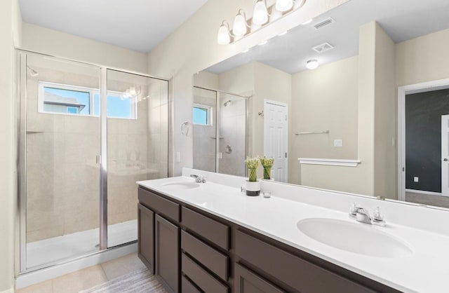246 Salt Springs Rd, Kyle, TX 78640 - full bathroom featuring double vanity, a stall shower, and tile patterned floors