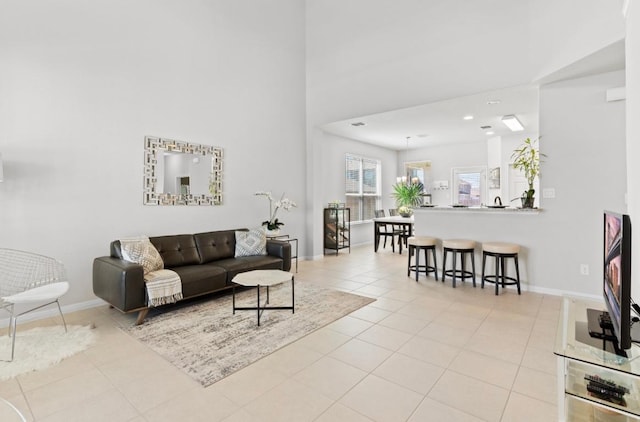 246 Salt Springs Rd, Kyle, TX 78640 - living area featuring baseboards, light tile patterned floors, and a towering ceiling